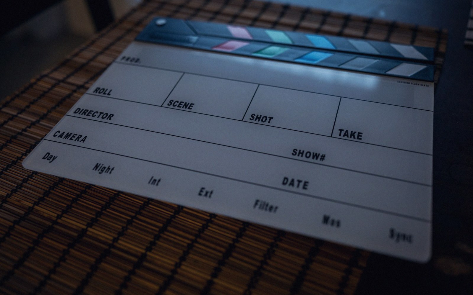 A clapper board face down beside a steel tape measure